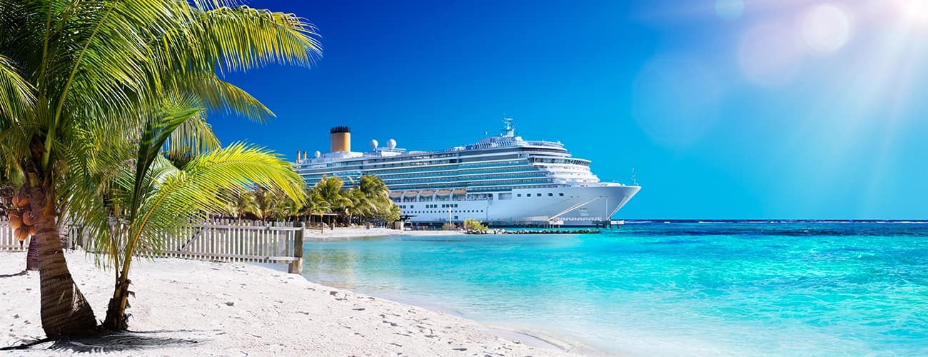 Cruise ship sailing across clear turquoise waters